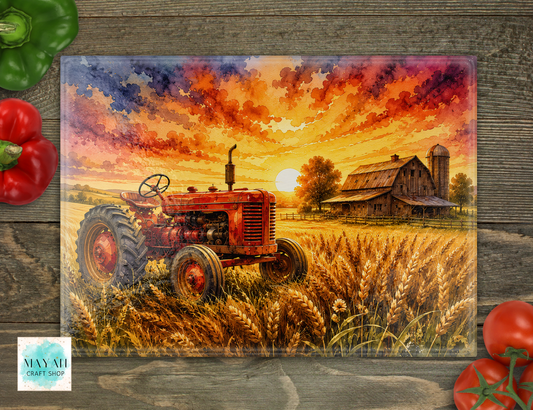 Cutting board of a red tractor in a field with a barn and sunset sky on a wooden surface.