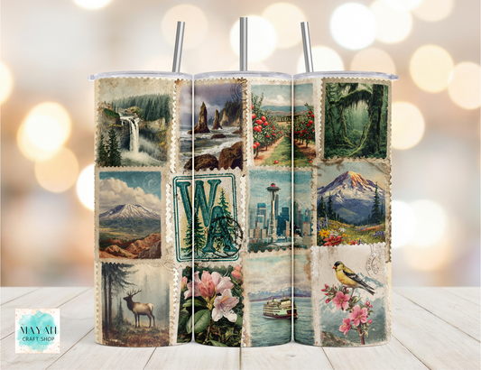 Tumbler with scenic and nature-themed design on a wooden surface with blurred lights in the background.