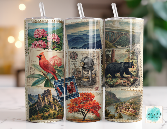 Three tumblers with scenic and nature-themed designs on a blurred background