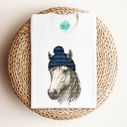 White t-shirt with a horse graphic on a woven mat.