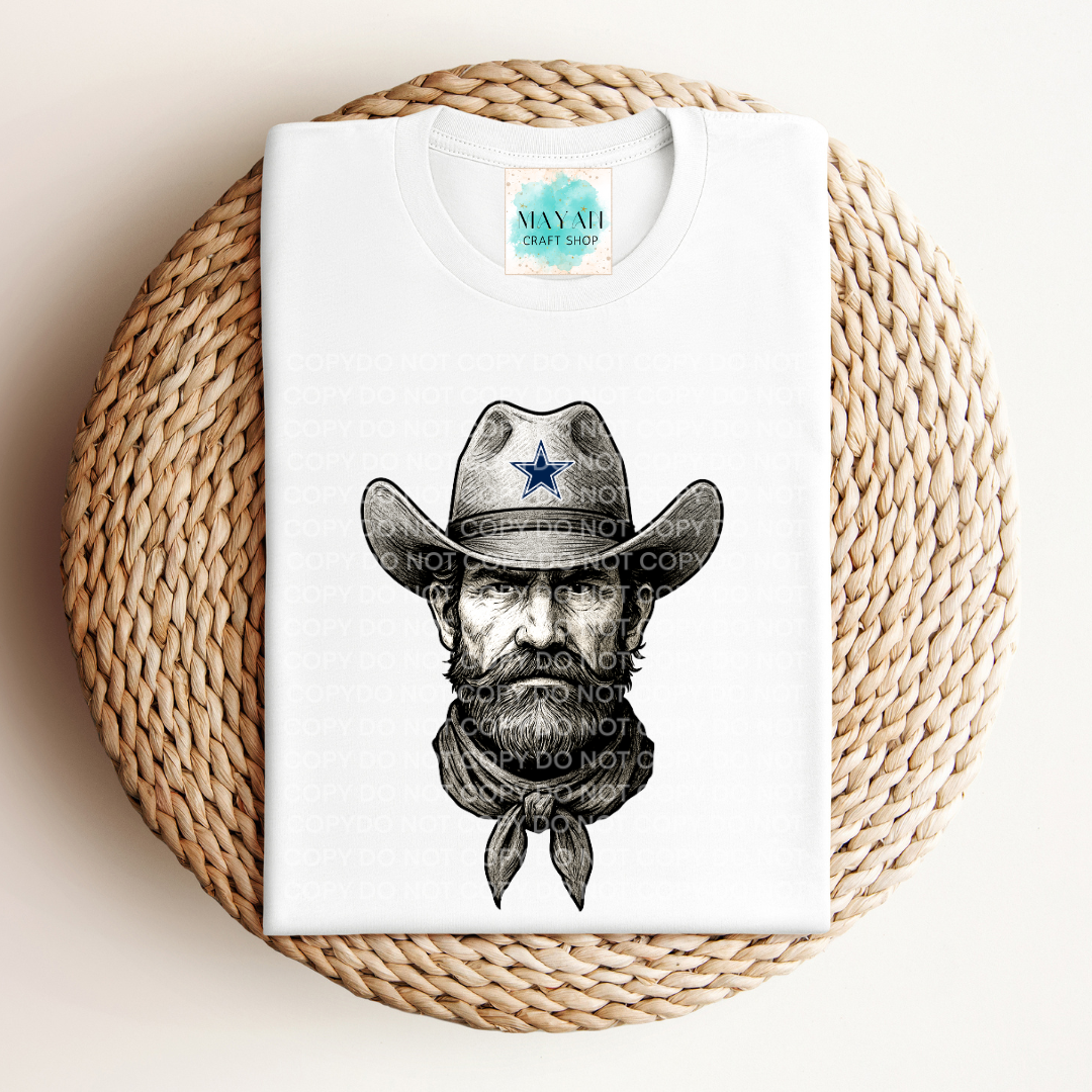 White t-shirt with a cowboy graphic on a woven mat