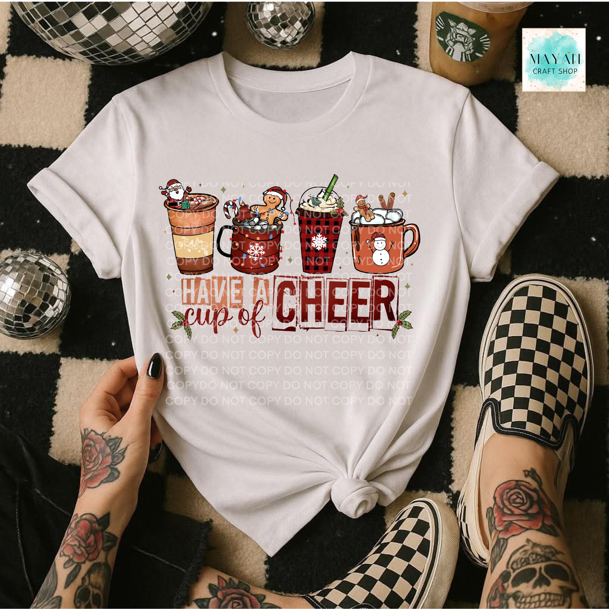 White t-shirt with Christmas-themed design and text 'Have a Cup of Cheer' worn by a person.