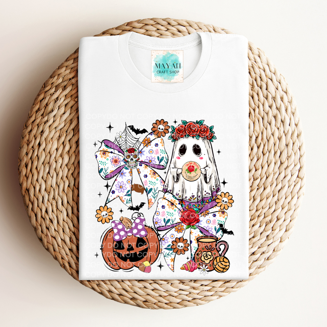 White t-shirt with colorful graphic design on a woven mat