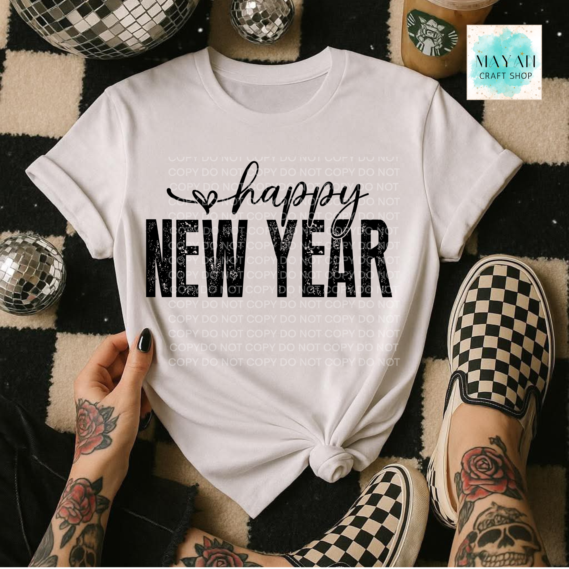 White t-shirt with 'happy NEW YEAR' text, worn by a person with tattoos and checkered shoes on a patterned floor.