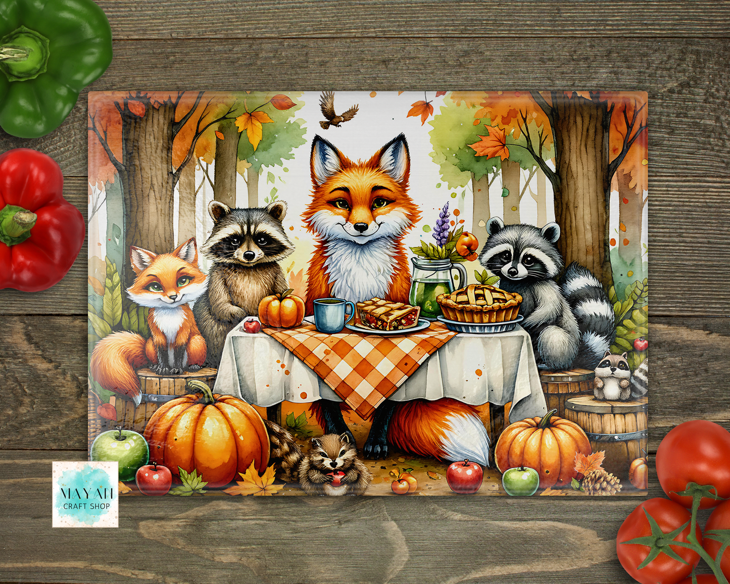 Cutting board of fox, raccoons, and a squirrel at a table with pumpkins and autumn decorations on a wooden background.