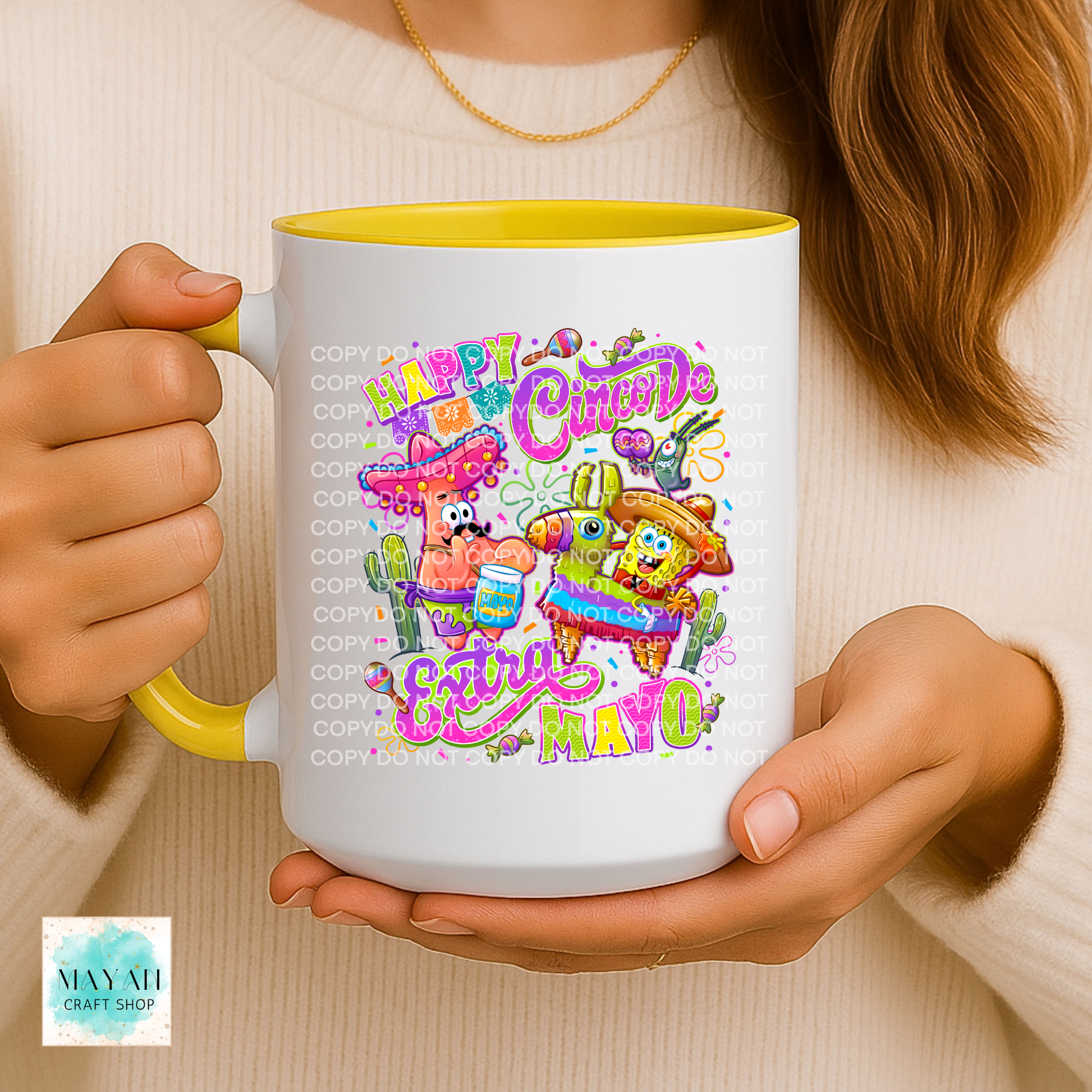 Person holding a mug with colorful 'Happy Cinco de Mayo' design