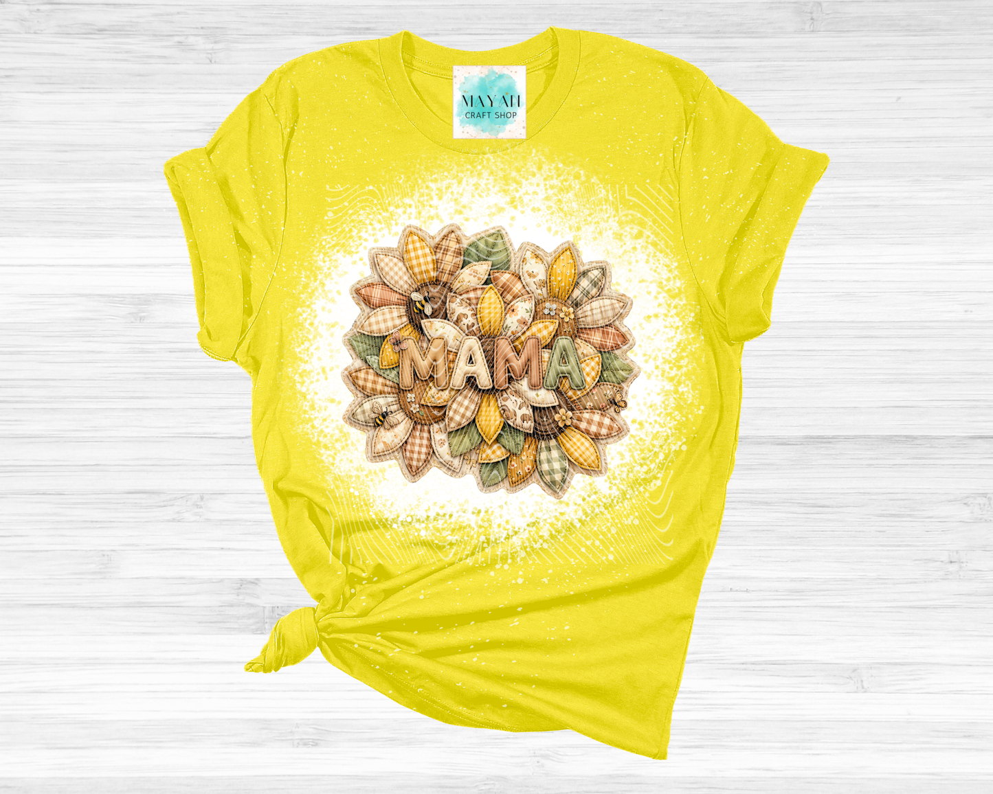 Yellow t-shirt with 'MAMA' design on a wooden surface