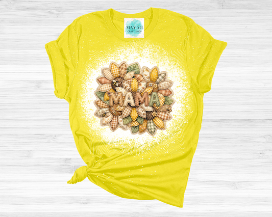 Yellow t-shirt with 'MAMA' design on a wooden surface