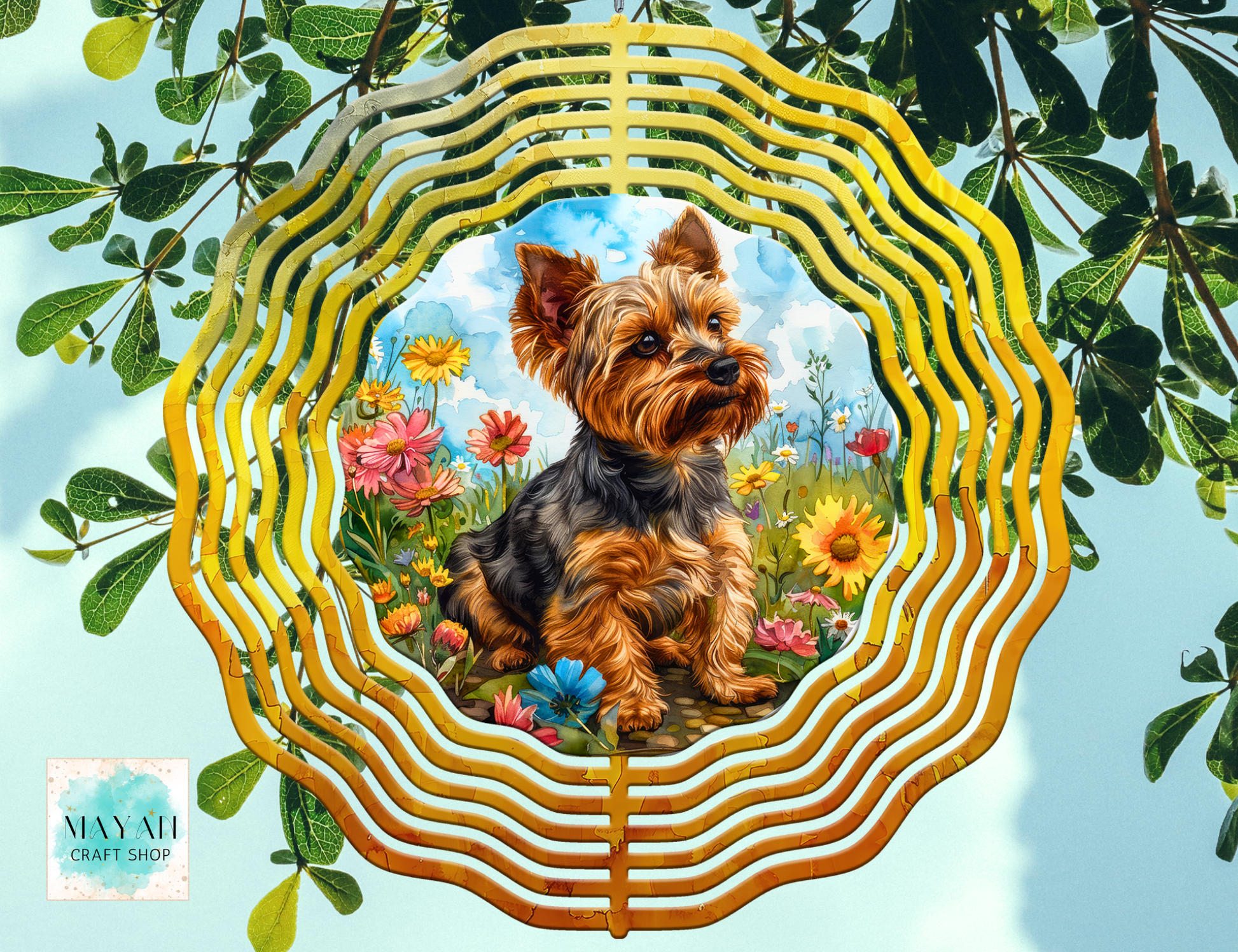 Yorkshire Terrier in a decorative wind spinner with flowers and leaves