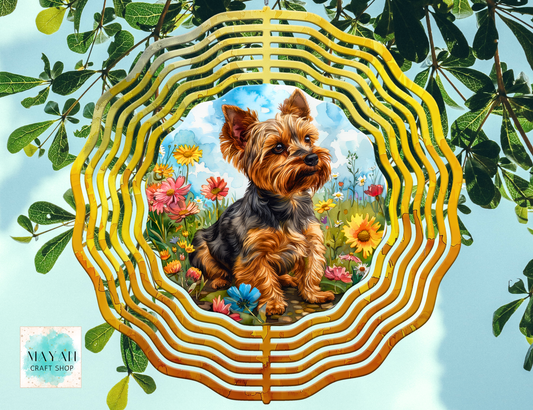 Yorkshire Terrier in a decorative wind spinner with flowers and leaves