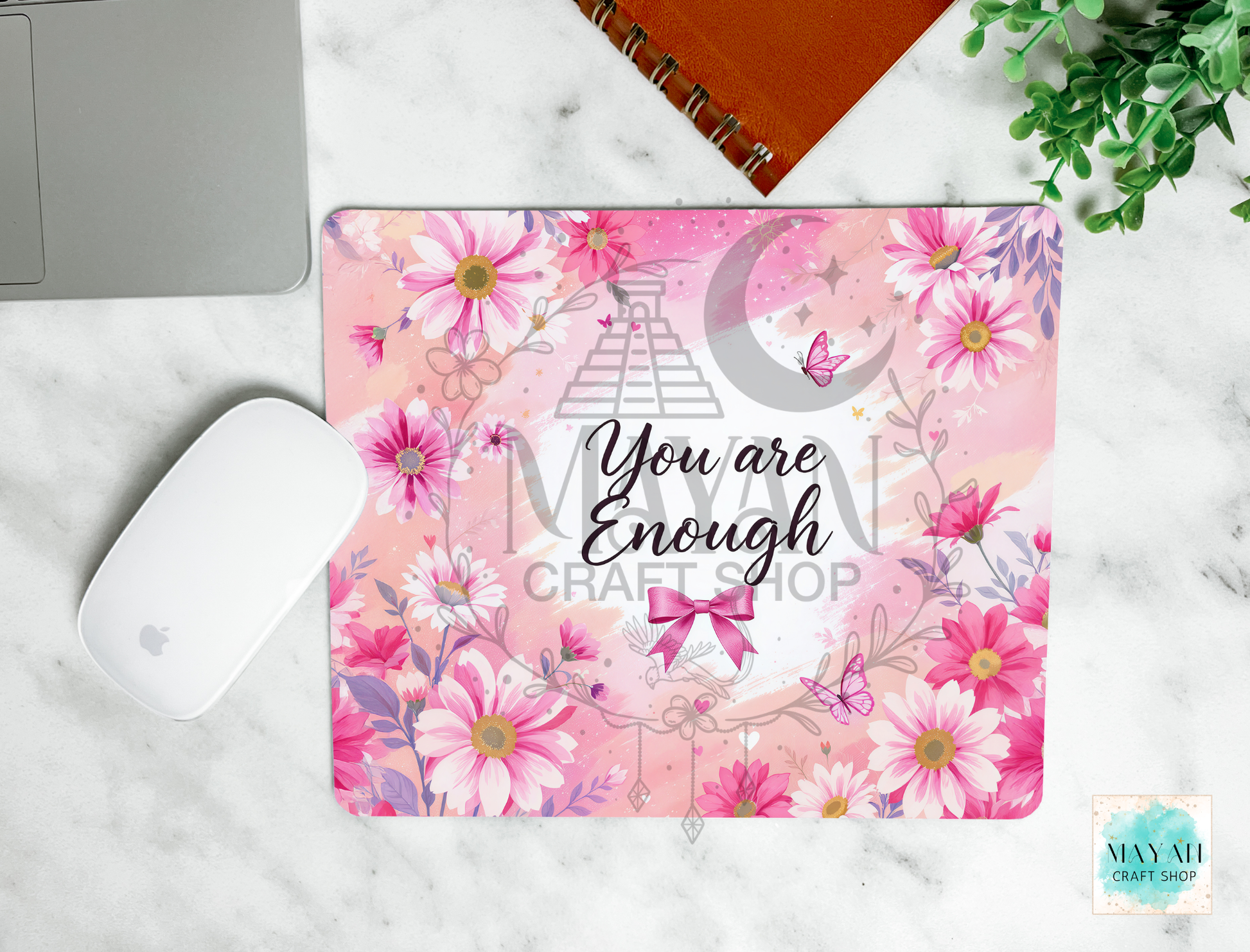 Floral mouse pad with motivational quote on a marble surface