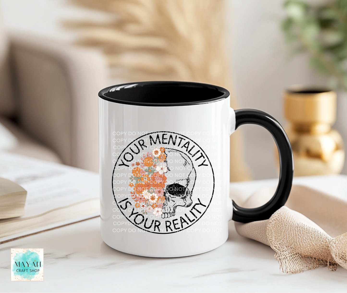 Mug with motivational quote on a table with books and decor